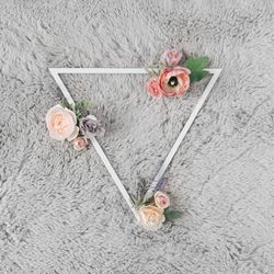 Triangle on grey carpet with flowers