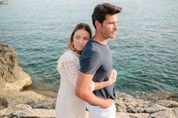 Happy couple hugging on seashore
