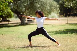 Arab woman doing yoga pose in nature
