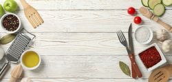 Composition with kitchen cutlery and ingredients for cooking on wooden background, top view