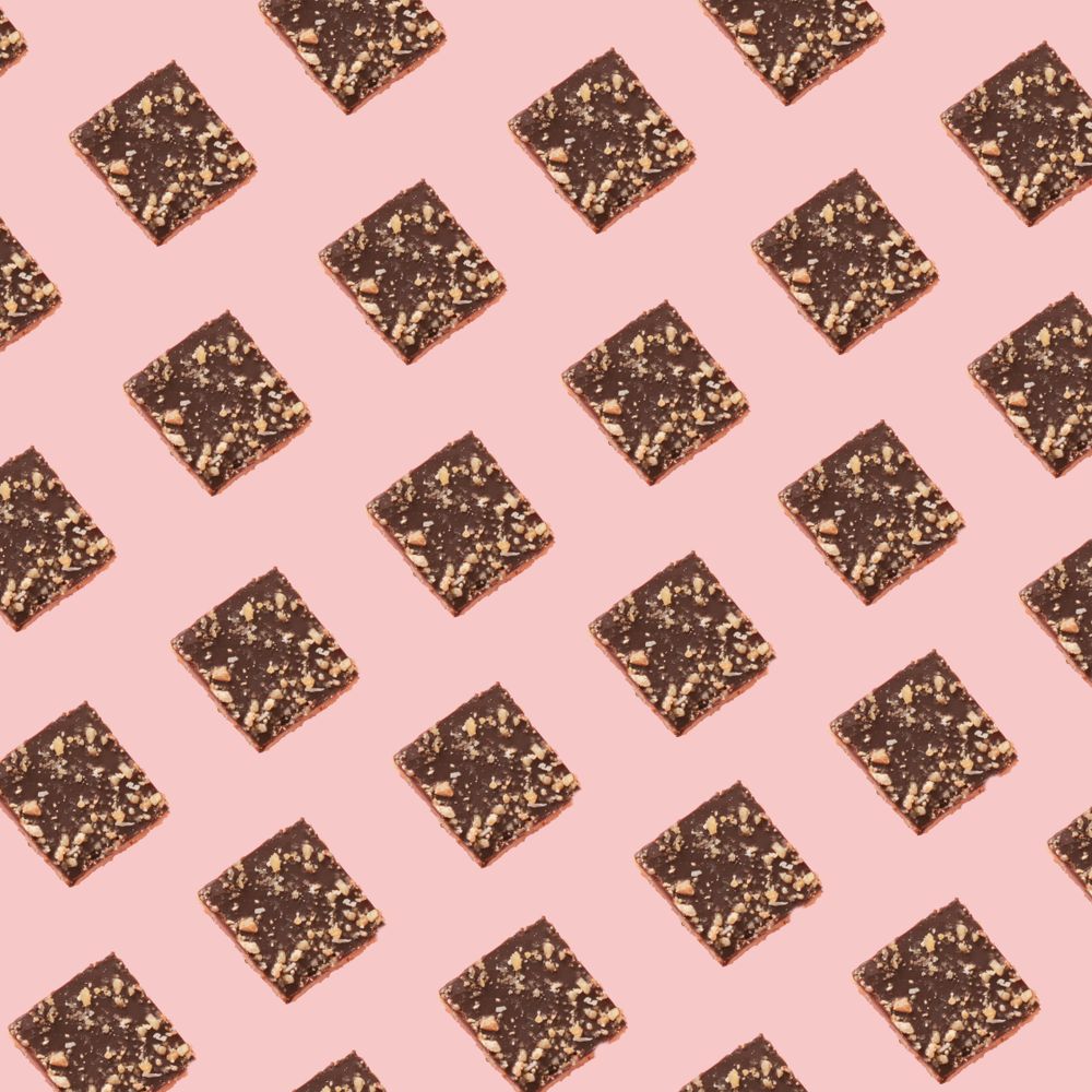 Chocolate square cookie pattern on a soft pink background
