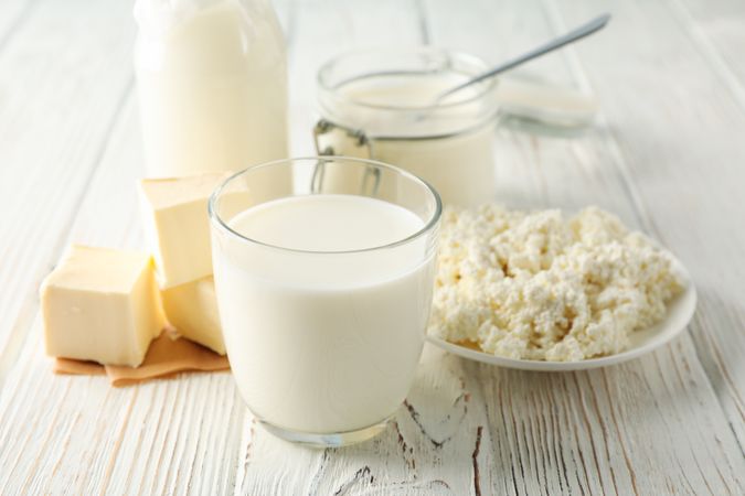 Different dairy products on wooden background, space for text
