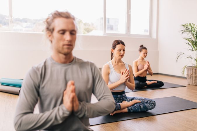 Group of people meditating in a yoga studio