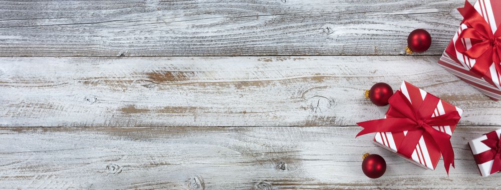 Merry Christmas with gifts and ornaments on rustic wooden background