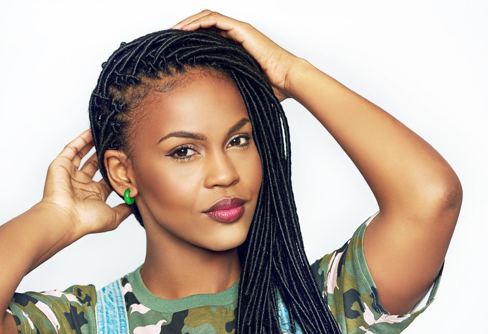 Portrait of confident woman with her hands to her hair