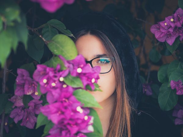 Woman on background of stunning violet flowers