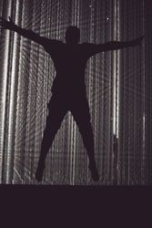 Tokyo, Japan - November 19th, 2019: Man star jumping in front of crystalline installation