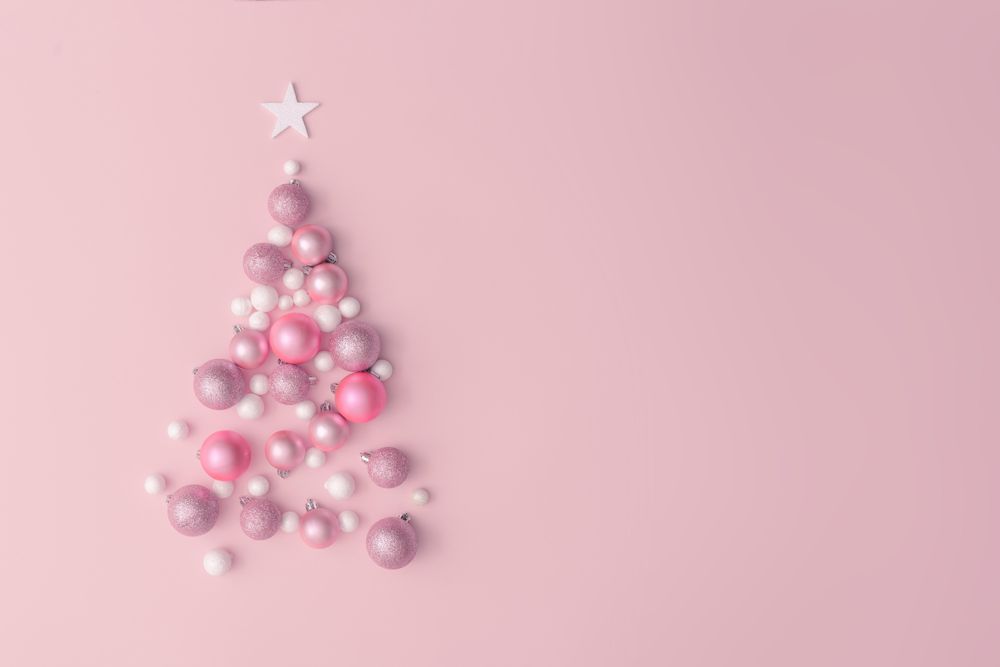 Christmas tree made of pink, purple and shiny glitter ball decoration on pink