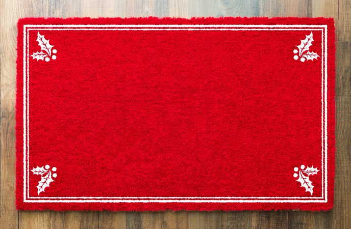 Blank Holiday Red Welcome Mat With Holly Corners On Wood Floor Background