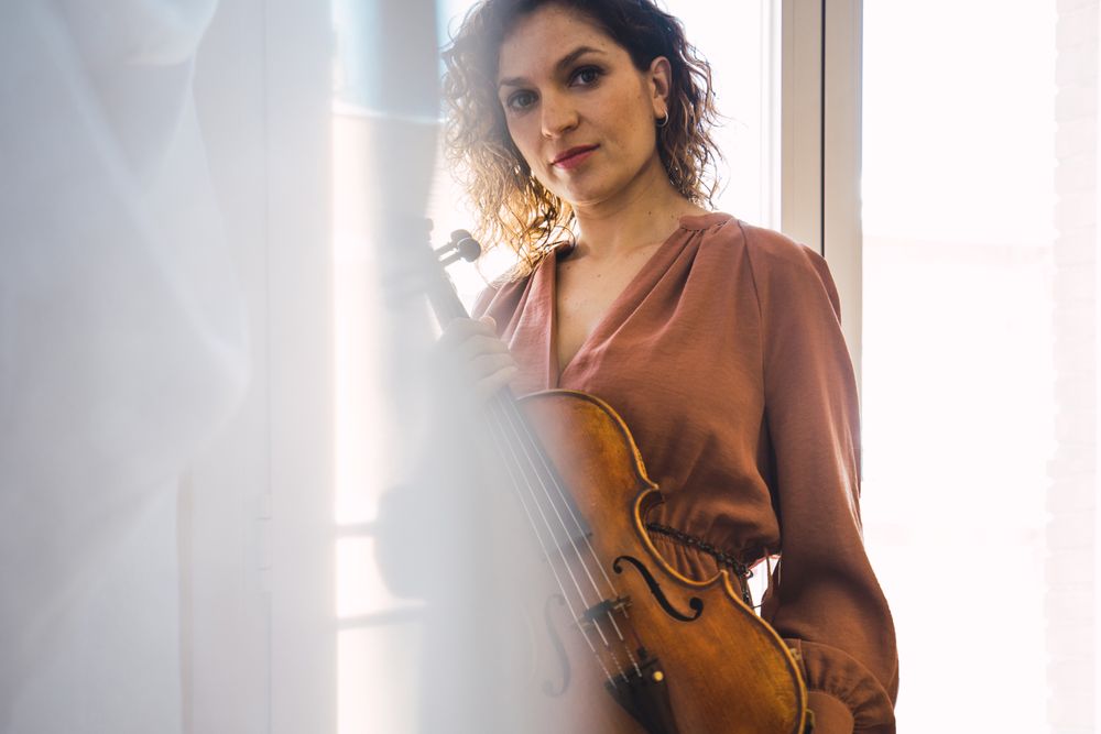 Young smiling woman with violin