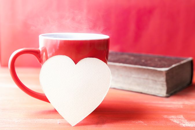 Paper heart on a cup of hot coffee
