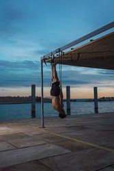 Athletic man balancing on gymnastic rings