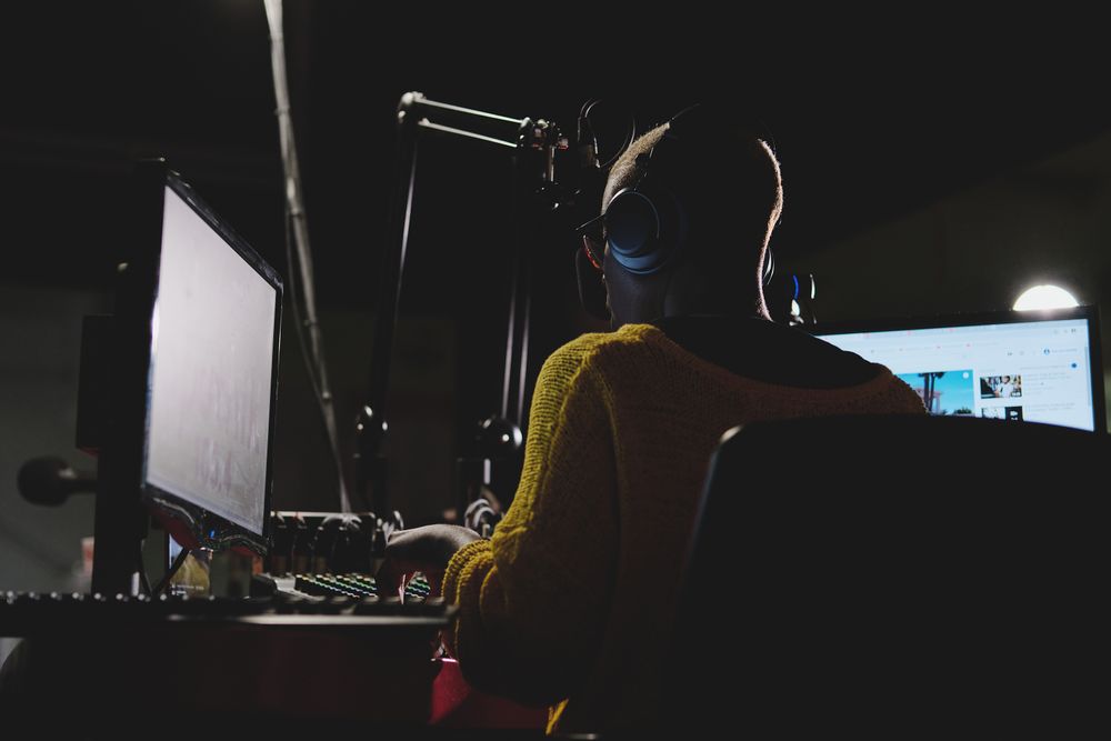 Unrecognizable woman operating sound mixer in recording studio