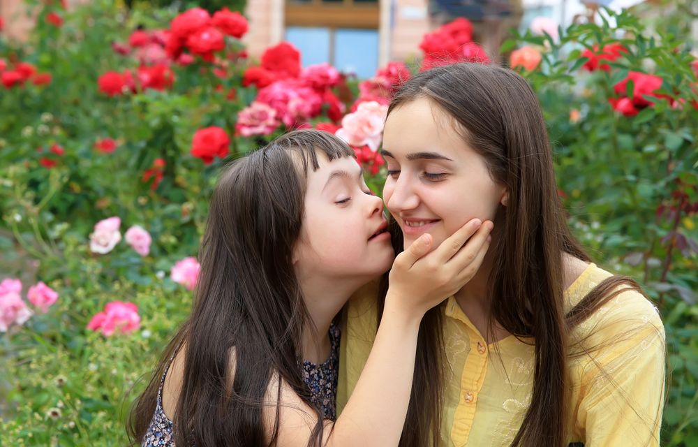 Two sisters being affectionate together