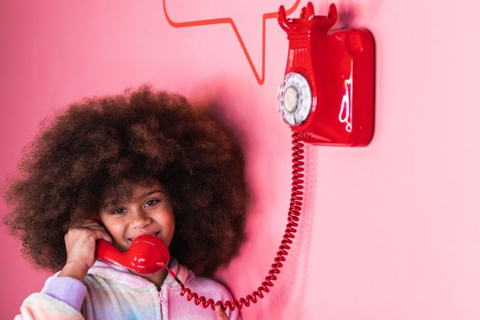 Black girl speaking on telephone in studio