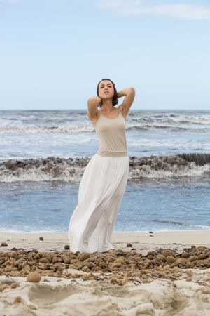 Charming young woman on shore near water