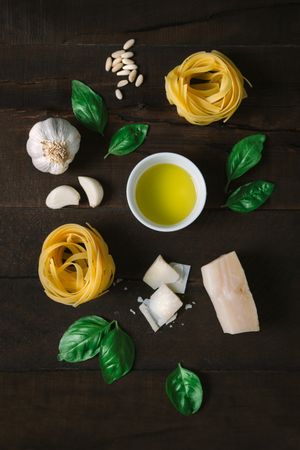 Ingredients for pesto pasta arranged at table