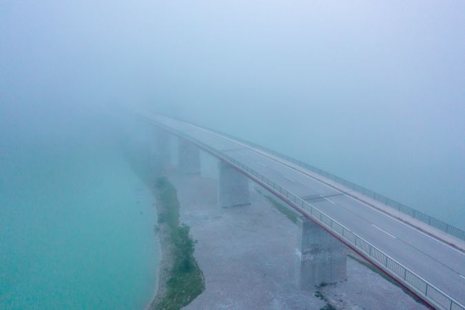 Aerial view image in the morning with Sylvenstein Bridge covered in fog