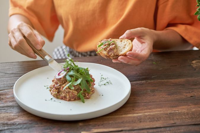 Unrecognizable female eating steak tartare