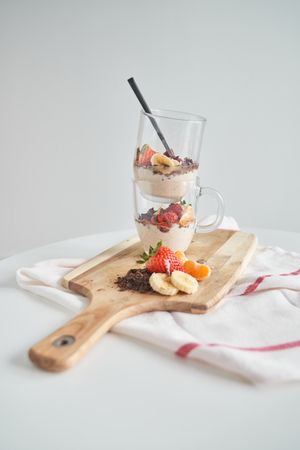 Glasses with delicious dessert served on table