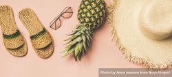 Sandals, glasses, pineapple, straw hat on pink background, wide composition 5QK8db