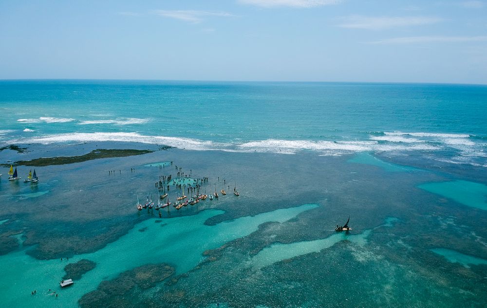 Sailboats & vacationers in the waters of Porto de Galinhas