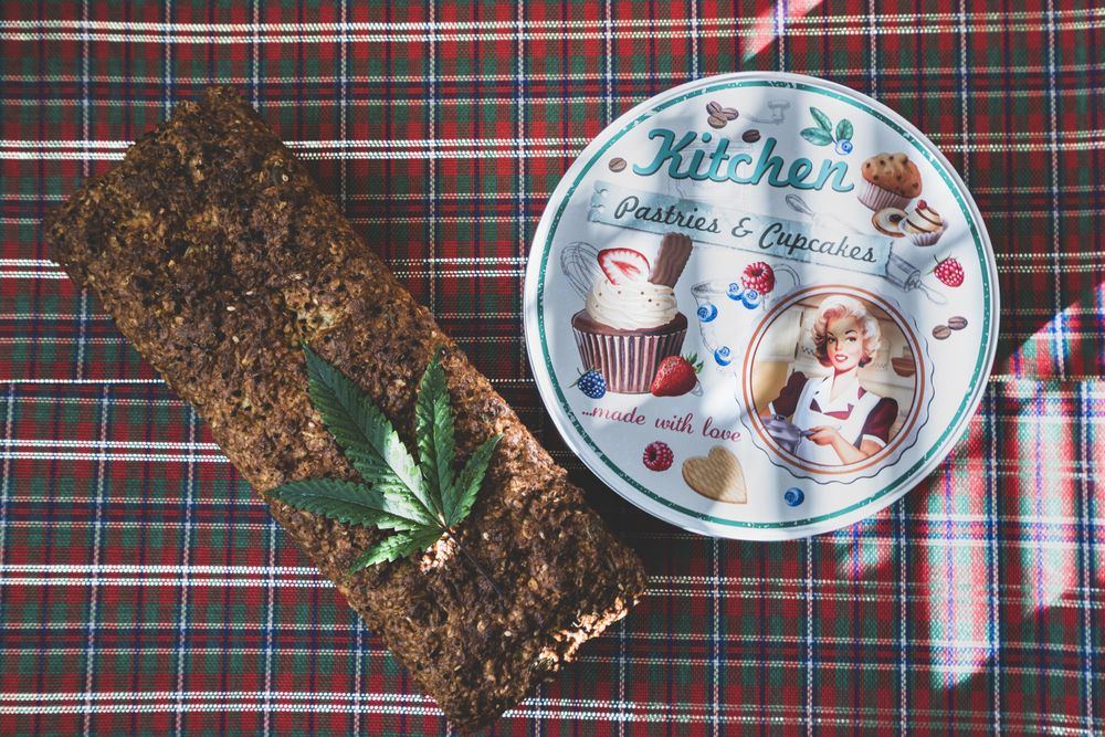 Loaf of grainy bread infused with cannabis and a cookie tin