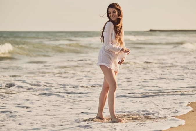 Woman with white dress at the beach