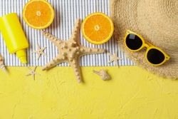 Summer vacation accessories on color background, space for text and top view. Happy holidays
