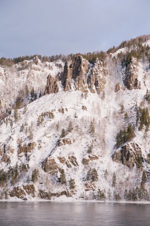 Wide Siberian river and snowy mountains