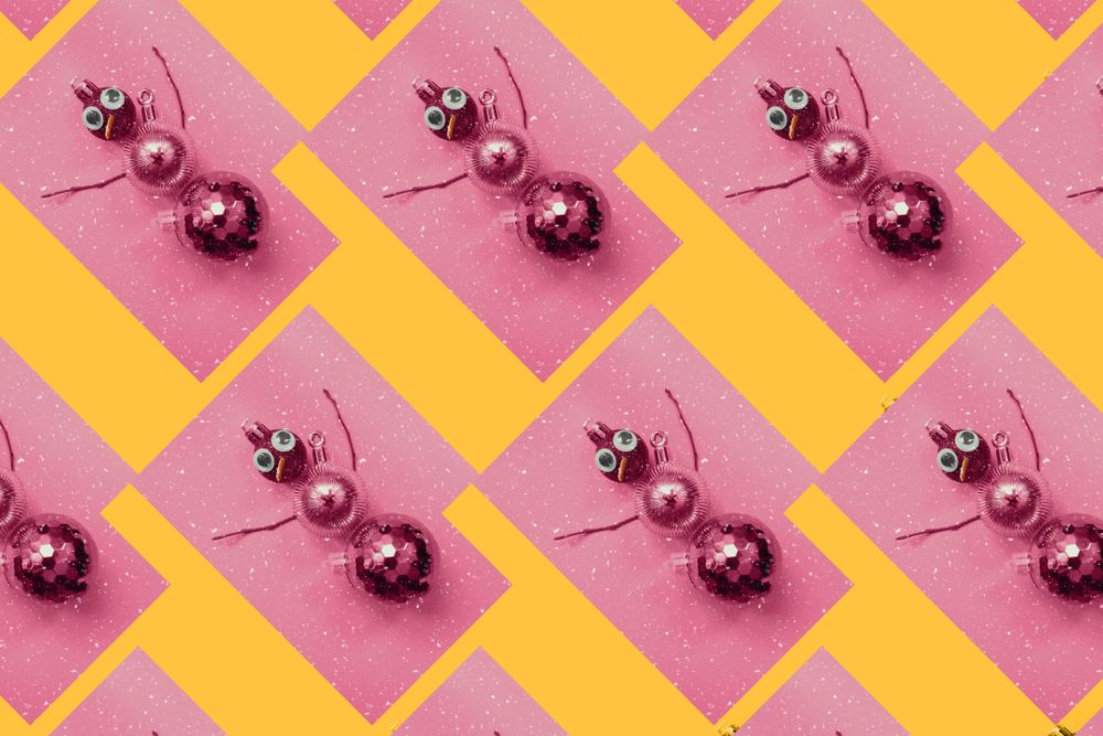 Rows of gold bauble snowman on pink and orange background