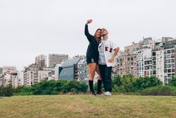 Friends smiling while making selfie on smartphone at city