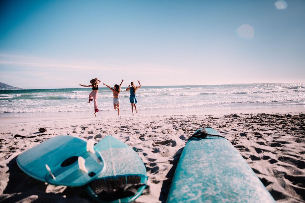 Group of women running into the ocean