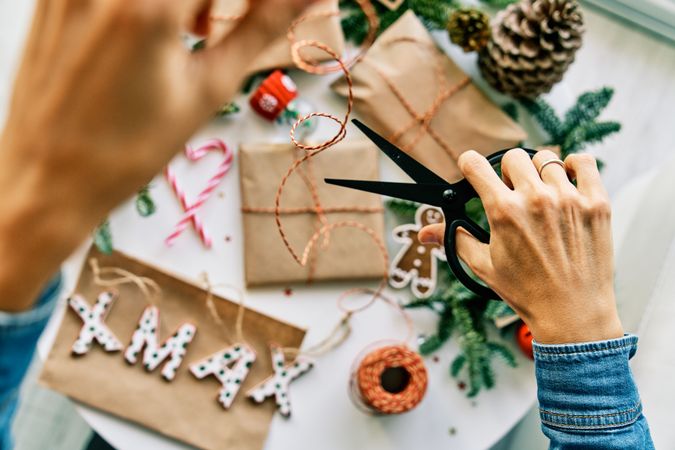 Crop woman wrapping Christmas presents