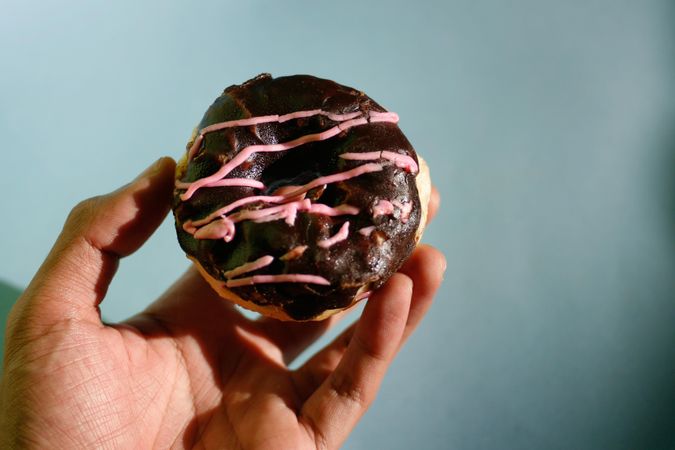 Chocolate donut with pink icing