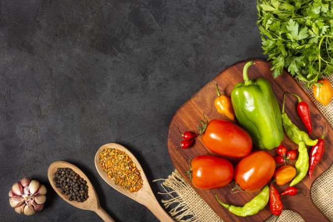 Ingredients for cooking with tomatoes, various peppers, garlic and green peppers.