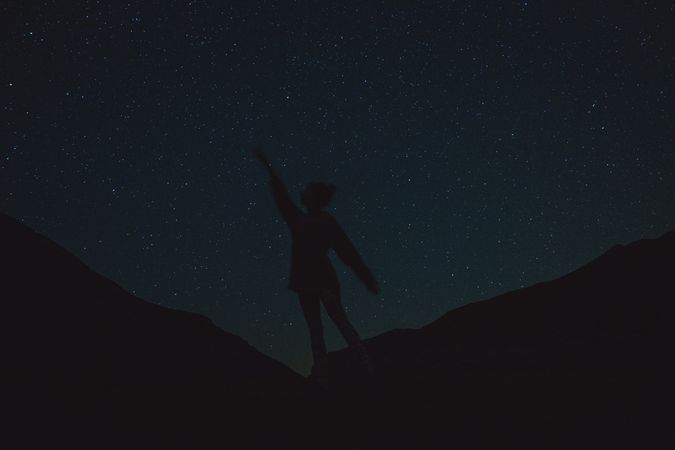 Silhouette of a person on a starry night