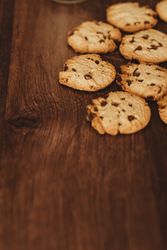 Savoring Simplicity: Homemade Cookies with a Glass of Milk on an Elegant Wooden Table.