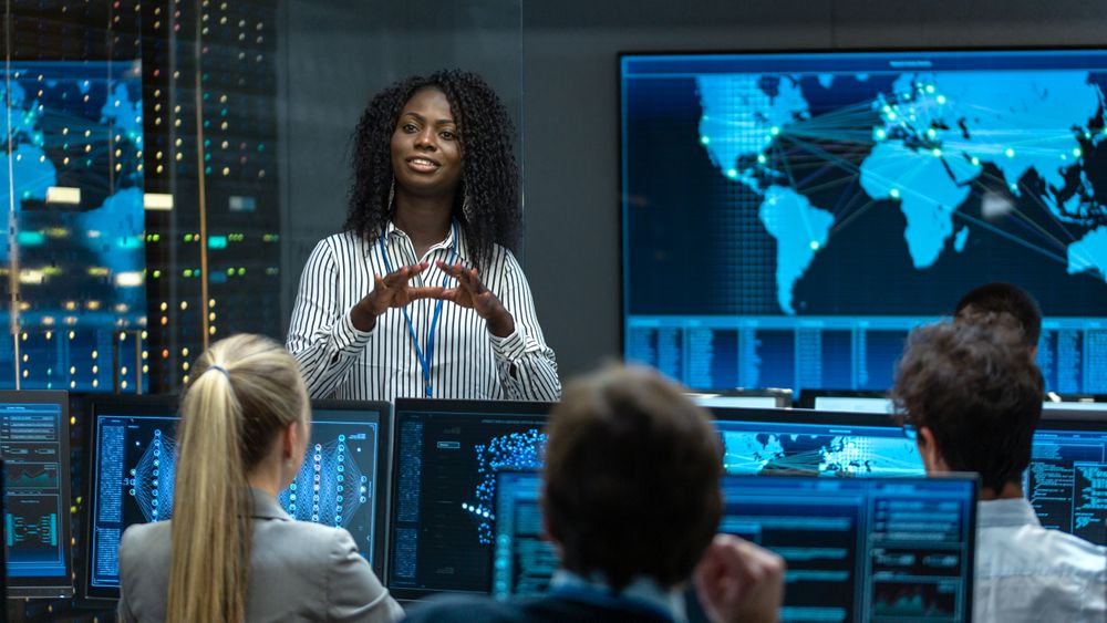 Chief Project Engineer Holds Briefing for a Team of Scientists that are Building Machine Learning System.