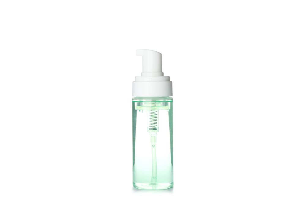 Liquid in spray bottle isolated on plain background