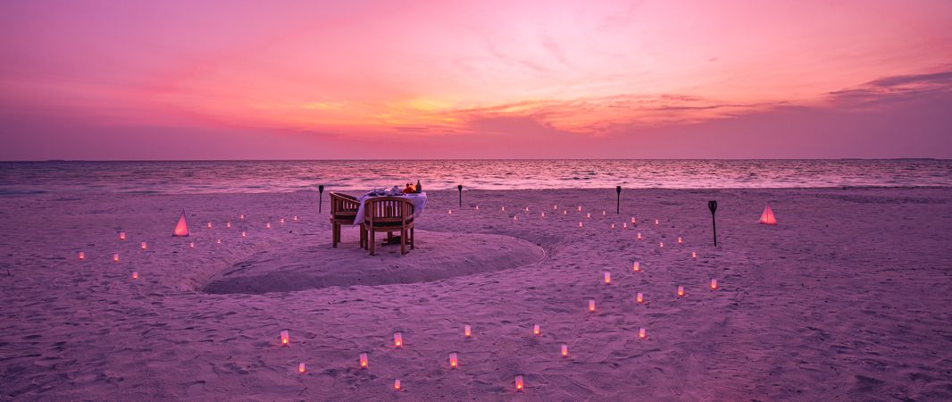 Romantic beach setting for dinner, wide shot