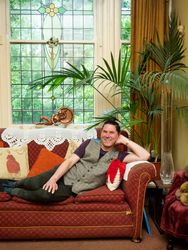 Man smiling at home lounging on stylish sofa
