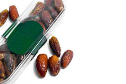 Dates fruit in plastic package with blank green label for product mockup design