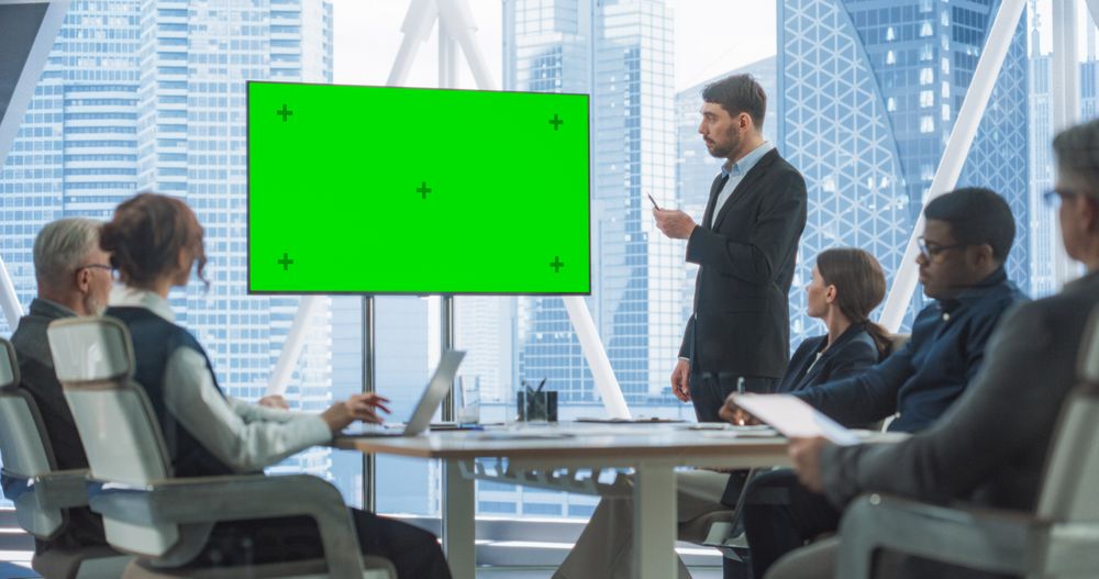 Office Conference Room Meeting Presentation: Businessman Talks, Uses Green Screen Chroma Key TV Set.