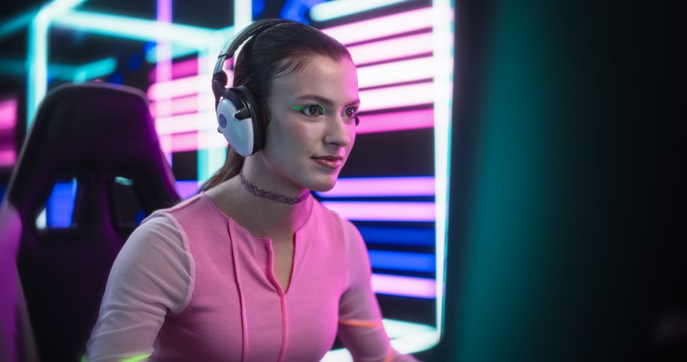 Stylish Streamer or Gamer Playing Games with Internet Players in a Futuristic Neon Studio Room
