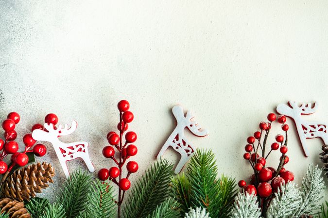 Wintry branches on bottom of image with reindeer decorations