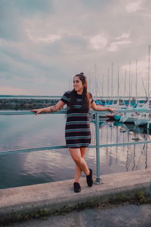 Smiling female walking standing on busy urban pier
