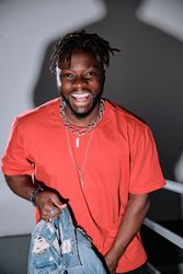 Smiling Black man standing on staircase