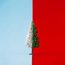 Decorated Christmas tree half with snow on duotone background