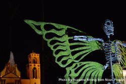 Large art piece of skeleton with wings at Dia de Los Muertos 0grAeb